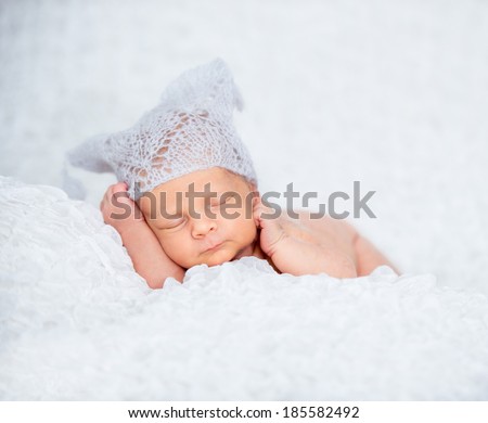 Newborn sweet baby boy sleep in a knitted hat