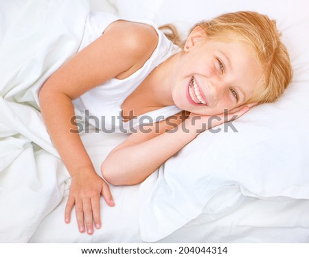 beautiful six year old girl lying in white bed