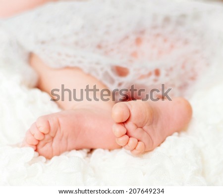 lovely little feet under soft blanket