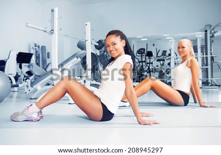 Young woman doing exercises at the fitness club