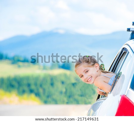Happy girl travel by car in the mountains. Summer vacation concept