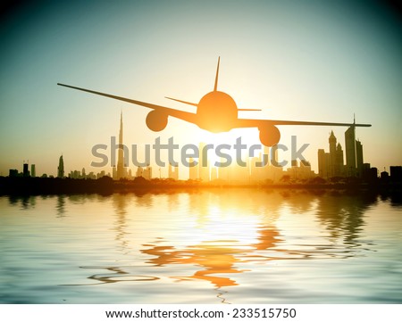 Dubai. plane flies on the background of a beautiful beach and sea.  United Arab Emirates.