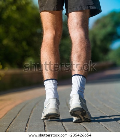close-up of men\'s sneakers running athlete. back view