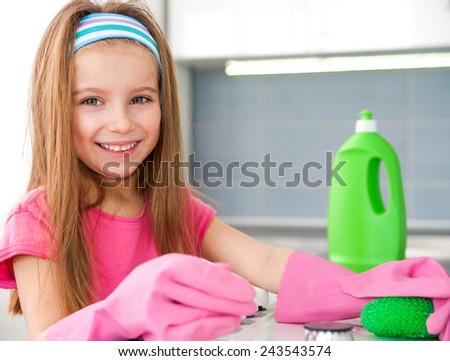 cute girl make cleaning in the kitchen