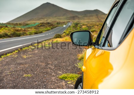 Yellow car on a background of mountains