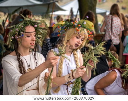 Warsaw, Poland -JUNE 20: Young girls make wreaths of flowers on festival of midsommar near the old town in Warsaw, Poland June 20, 2015