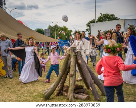 Warsaw, Poland -JUNE 20: People dance around a bonfire logs on a festival of midsommar near the old town in Warsaw, Poland June 20, 2015