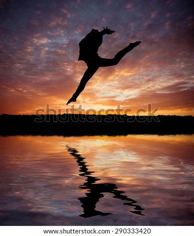 silhouette jumping  gymnast on the background of beautiful sunset on the beach