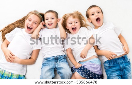 children in white shirts lying on the floor isolated on white background