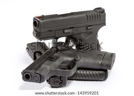 Stacked Handguns/Stacked Handguns/Three Handguns stacked representing security, defense, home protection.