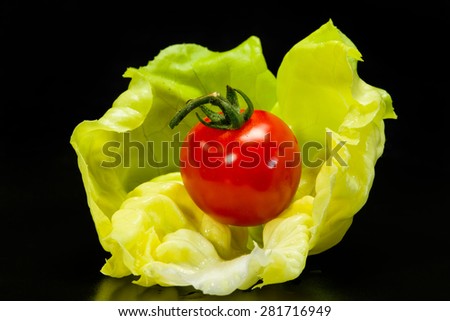 Lettuce and tomato on a black background