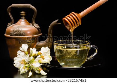 Acacia honey - honey in a bowl and acacia flowers