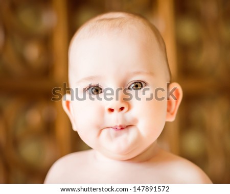 Closeup portrait of a cute little baby making a face