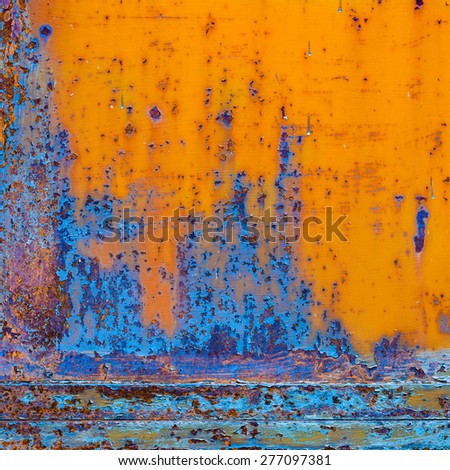 Rusty painted metal with cracked paint. Orange and blue textured grunge background