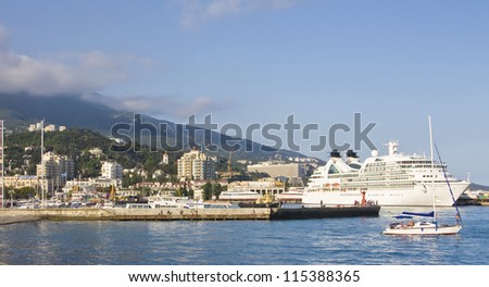 YALTA, CRIMEA - MAY 22: big cruise ship and little yachts in port in town Yalta, famous resort in region Crimea on Black sea in Ukraine, called \