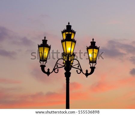 Street lamp on sky with sunset in the evening, recorded in Moscow on Manezhnaya square.