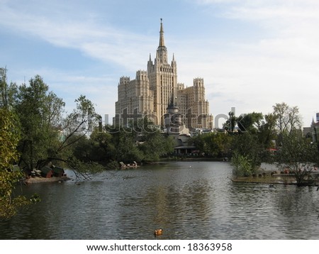 Moscow, Russia. Big building of thirties of XX century and entrance to the Zoo with lake.