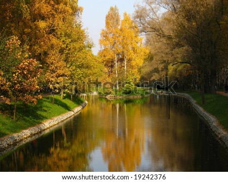 Autumn landscape - little island with trees on the lake - recorded in Sokolniki park in Moscow Russia