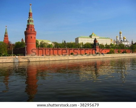 Moscow, Kremlin fortress with cathedrals and palace inside, on bank of Moscow-river, reflection of buildings in water.