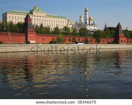 Moscow, Kremlin fortress with palace and cathedrals inside, on bank of Moscow-river, reflection of buildings in water.