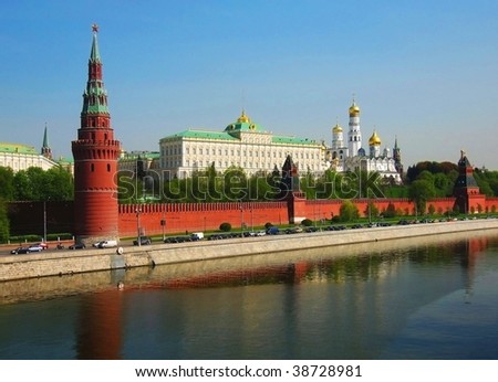 Moscow, Kremlin fortress with palace and cathedrals inside, on bank of Moscow-river, reflection in water.