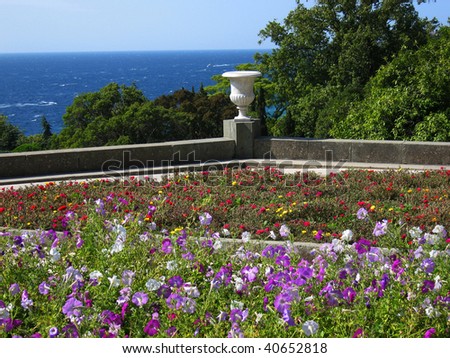 Sea landscape with park on sea shore, flowers, plants, garden vase. Recorded in park belongs to Vorontsovskiy palace in Crimea on Black sea in Ukraine.