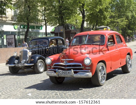 LVOV, UKRAINE - MAY 11: old retro Ukrainian-Russian car Zaporozhets (other names Eliette, Yalta, ZAZ) and mercedes benz on rally in holiday day of town City Day on May 11, 2013 in Lvov, Ukraine.