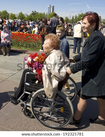 MOSCOW - MAY 9, 2014: Holiday Victory Day devoted to victory in Second World War, invalid - war veteran on the street.