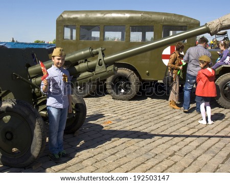 MOSCOW - MAY 9, 2014: Holiday Victory Day devoted to victory in Second World War, children play on exhibition of vintage military technique on memorial Poklonnaya hill.