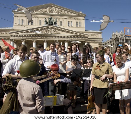 MOSCOW - MAY 9, 2014: Holiday Victory Day devoted to victory in Second World War, people sing war songs near Big Theatre.