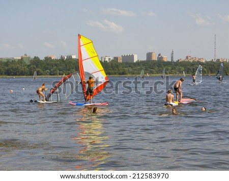 MOSCOW - JUNE 27, 2010: members of windsurfing school in district Strogino train on Moscow-river to Russian and world competitions.