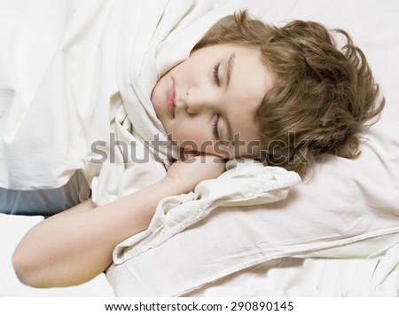 Head of sleeping boy in bed, Caucasian, eight years.