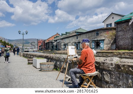 OTARU,JAPAN - 7 May 2014: A artist present their works to passing tourists at Otaru canal