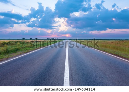Asphalt road towards the rising sun