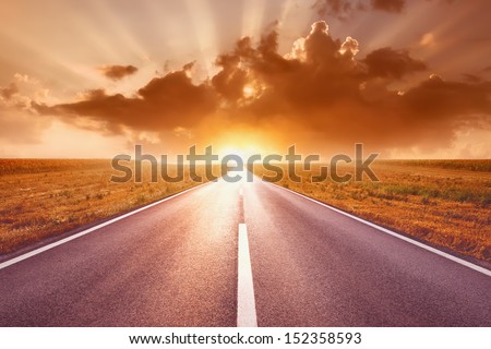 Driving on an empty highway to the sun
