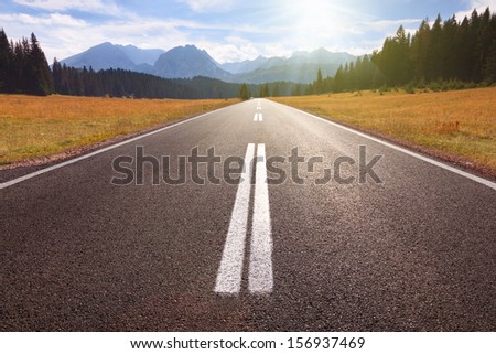Driving On An Empty Road To The Sun