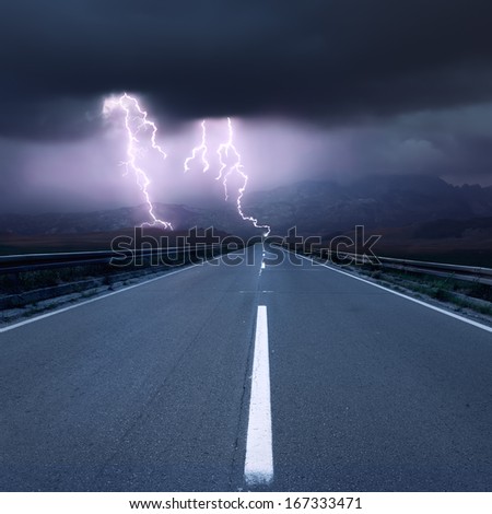 Driving on an empty asphalt road at thunderstorm