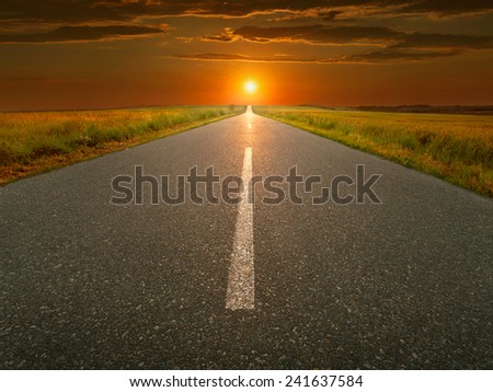 Empty open road towards the setting sun.