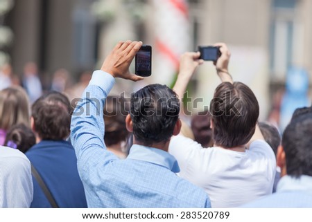 Photographing with mobile phones in the crowd at a concert. Shallow depth of field.