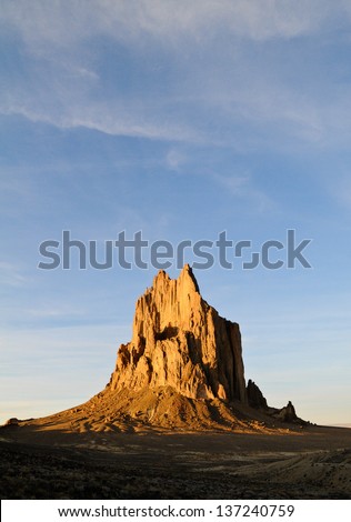 Sunset on Shiprock in the New Mexico desert with blue sky