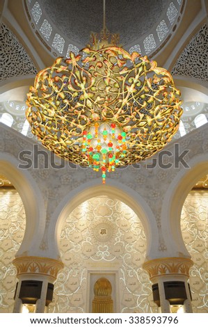 ABU DHABI, UAE - November 8: The main chandelier at Sheikh Zayed Grand Mosque glows on November 8, 2015 in Abu Dhabi, UAE.