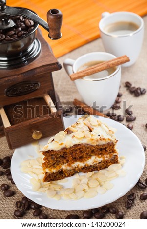 Coffee grinder, cup of coffee and cake