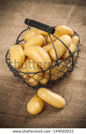 Basket of potatoes on hemp bag