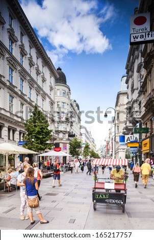 VIENNA, AUSTRIA - SEPTEMBER 01; Tourists form all over the World walks among one of the main streets, Kartner Strasse form Wiener City Opera to Stephansplatz; September 01, 2013 in Vienna, Austria.