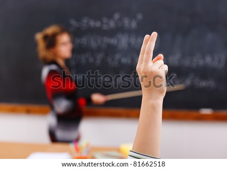 Raised hand of a student during math class