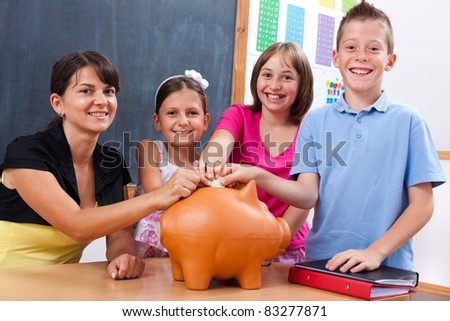 Students and teacher saving money by putting big coin into piggy bank