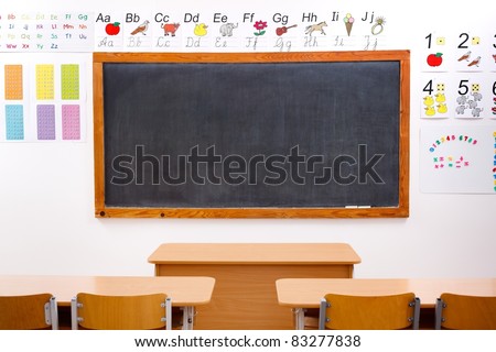 Empty classroom and black chalkboard, decorated with letters and numbers