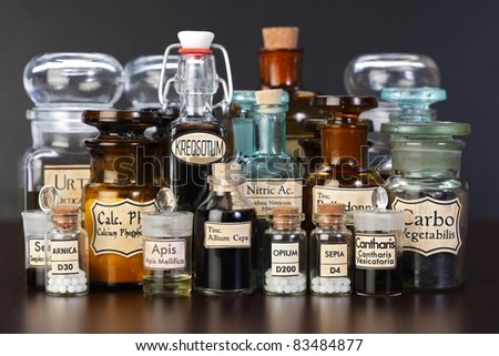 Various pharmacy bottles of homeopathic medicine on dark background