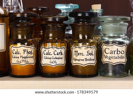 Various pharmacy bottles of homeopathic medicine on dark background
