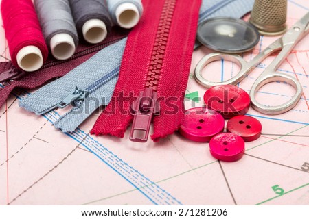 Red and grey sewing accessories on pattern cutting